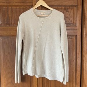 Hem and thread asymmetrical sweater